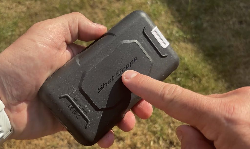 Shot Scope H50 handheld golf GPS being used on a golf course showing a full-colour hole map and yardages. Magnet. 